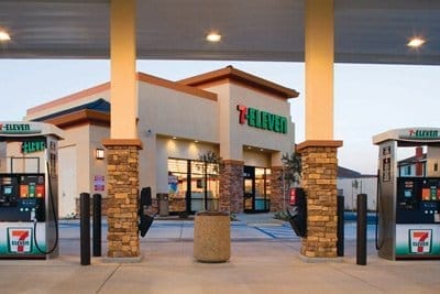 A 7-Eleven franchise convenience store with fuel pumps at dusk.
