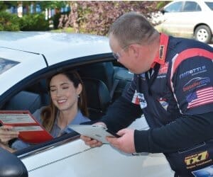 Grease Monkey franchisee serving a customer