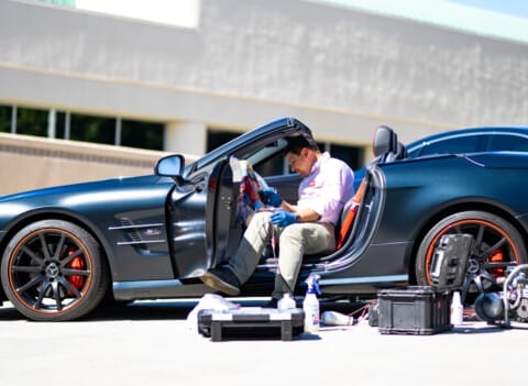 a Fibrenew franchisee restoring the interior of a parked convertible car.