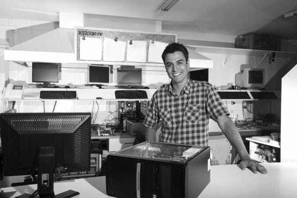 A happy Franchise buyer standing inside his business.